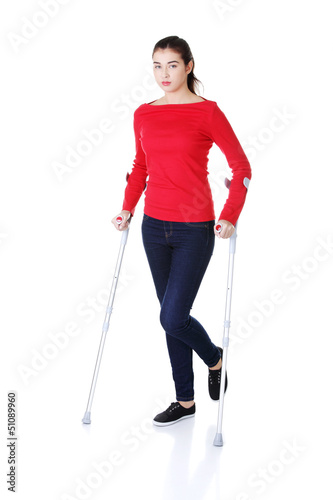 Photo: Woman walking with crutches Woman walking with crutches