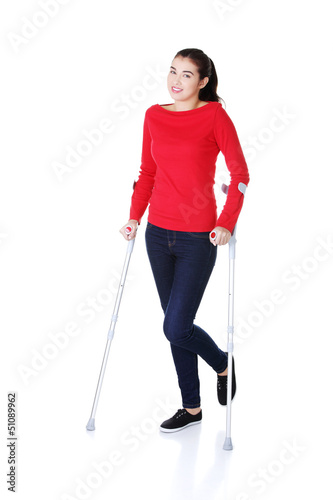 Photo: Woman walking with crutches Woman walking with crutches