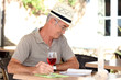 Man sat reading book on terrace