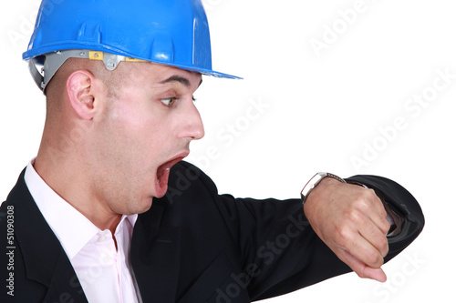 Photo: An architect looking at his watch. An architect looking at his watch.