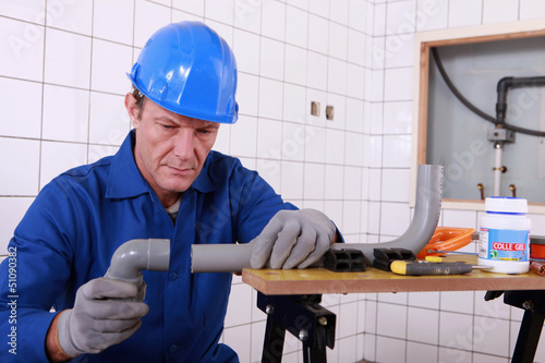 Photo: craftsman assembling pipes craftsman assembling pipes