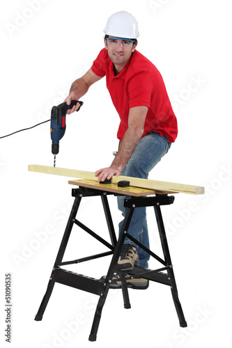 Photo: Carpenter using cordless drill Carpenter using cordless drill