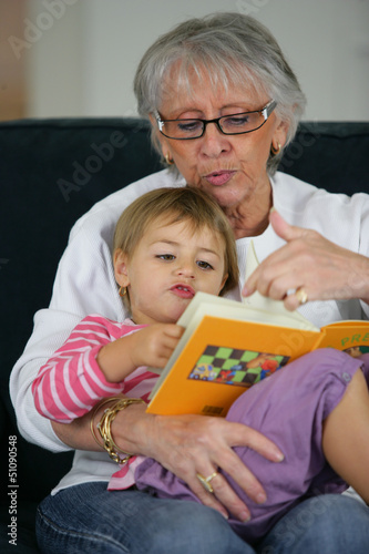 Photo: Grandma and child reading together Grandma and child reading together