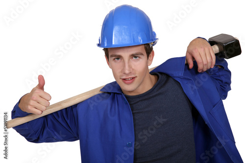 Photo: portrait of junior carpenter with hammer portrait of junior carpenter with hammer