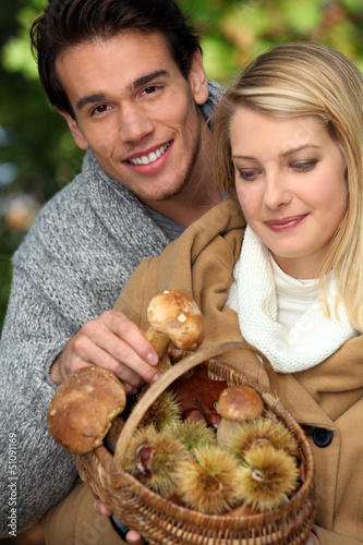 Photo: Couple gathering mushrooms Couple gathering mushrooms
