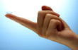 contact lens on finger on blue background