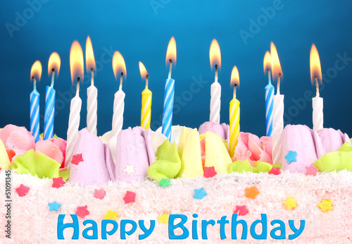 Photo: Birthday cake with candles on blue background Birthday cake with candles on blue background