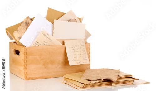 Photo: Wooden crate with papers and letters isolated on white Wooden crate with papers and letters isolated on white