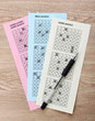 Lottery tickets and pen, on wooden background