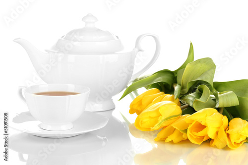 Photo: Tea set and tulips isolated on white Tea set and tulips isolated on white