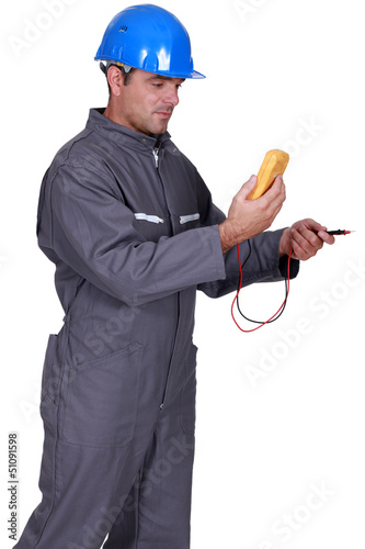 Photo: Electrician with voltmeter Electrician with voltmeter