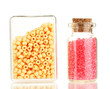 Foto: Colorful beads heap in box and glass bottle isolated on white Colorful beads heap in box and glass bottle isolated on white