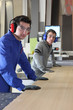 Foto: Two men working an industrial saw Two men working an industrial saw