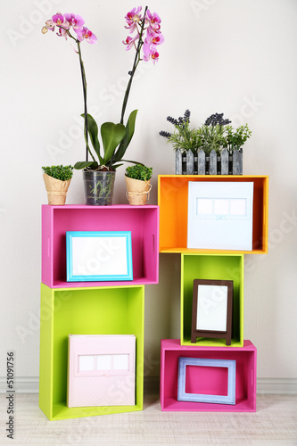Photo: Beautiful colorful shelves with different home related objects Beautiful colorful shelves with different home related objects