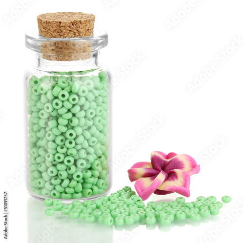 Photo: Little bottle full with colorful beads isolated on white Little bottle full with colorful beads isolated on white