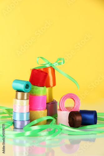 Photo: Many bright ribbons of different sizes on light background Many bright ribbons of different sizes on light background