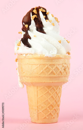 Photo: Tasty ice cream with chocolate, on pink background Tasty ice cream with chocolate, on pink background
