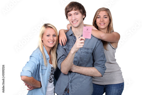 Photo: girls and boy holding driving license girls and boy holding driving license