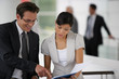 Businesspeople reviewing paperwork