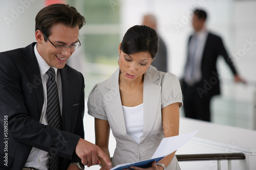 Photo: Businesspeople reviewing paperwork Businesspeople reviewing paperwork