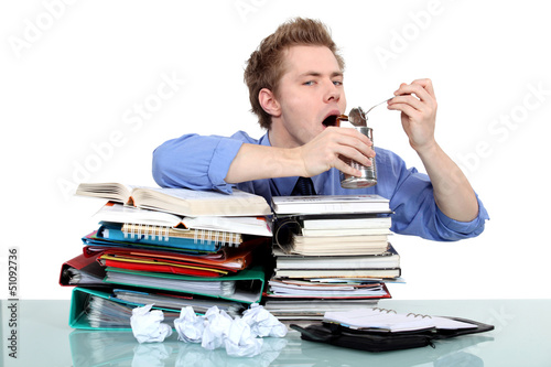 Photo: overwhelmed worker eating from a tin overwhelmed worker eating from a tin