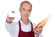 Senior wine waiter showing businesscard