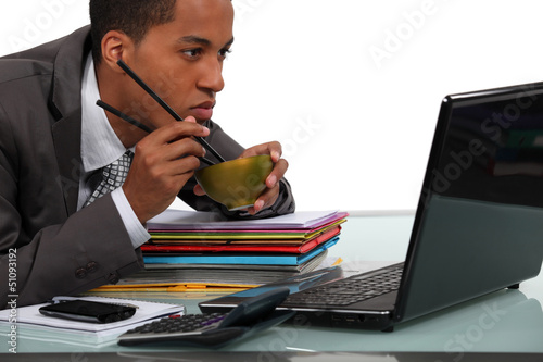 Photo: Businessman eating chinese food at his desk Businessman eating chinese food at his desk