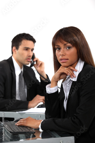 Photo: Two business colleagues working side by side Two business colleagues working side by side
