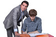 Teacher helping male teenager