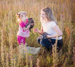 Photo: little girl and mother with cats outdoor little girl and mother with cats outdoor