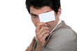 Businessman holding a  card