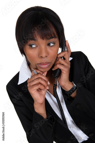 Photo: Woman paying attention during phone call Woman paying attention during phone call