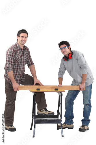 Photo: Carpenters working at a bench Carpenters working at a bench