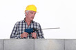 Worker with a masonry drill