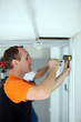 Photo: Two workers measuring width of wall Two workers measuring width of wall