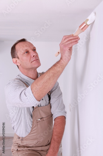 Photo: Painter painting wall Painter painting wall