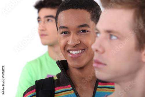 Photo: Young man surrounded by his peers Young man surrounded by his peers