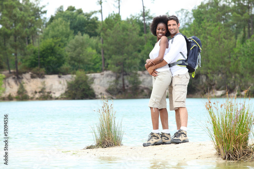 Photo: Hiking couple stood by lake Hiking couple stood by lake