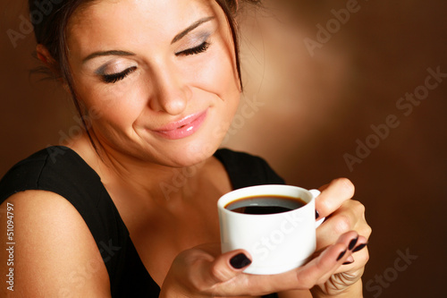 Photo: Portrait of a woman drinking coffee Portrait of a woman drinking coffee