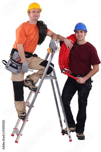 Photo: A team of tradesmen posing with their tools A team of tradesmen posing with their tools