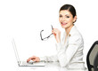 woman sits from the  table and working on laptop