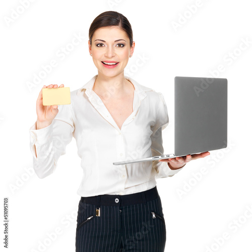Photo: Woman in white shirt with laptop and credit card Woman in white shirt with laptop and credit card
