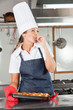 Female Chef Licking Finger