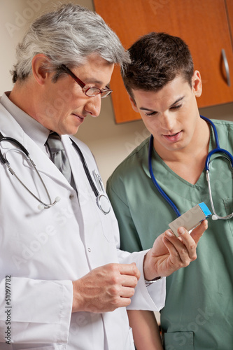 Photo: Medical Professionals Looking At Medicine Box Medical Professionals Looking At Medicine Box