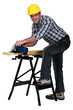 carpenter at work with sander machine isolated on white