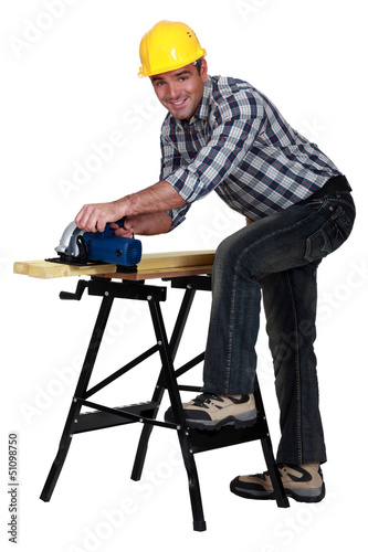 Photo: carpenter at work with sander machine isolated on white carpenter at work with sander machine isolated on white