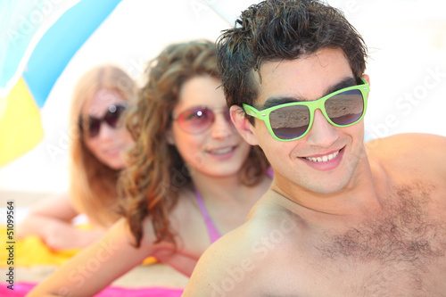 Photo: Youth on the beach wearing sunglasses Youth on the beach wearing sunglasses