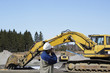 site engineer with giant bulldozers and trucks in action