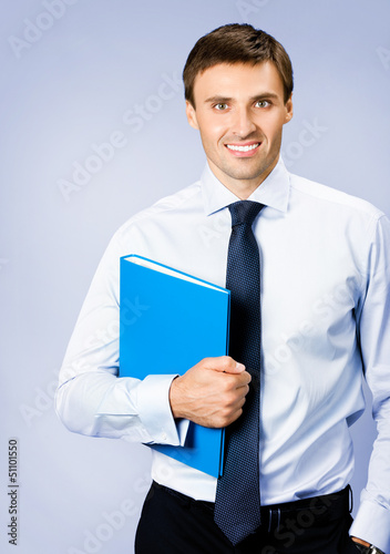 Photo: Business man with folder, on violet Business man with folder, on violet
