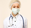 A female doctor wearing a mask, isolated on white background